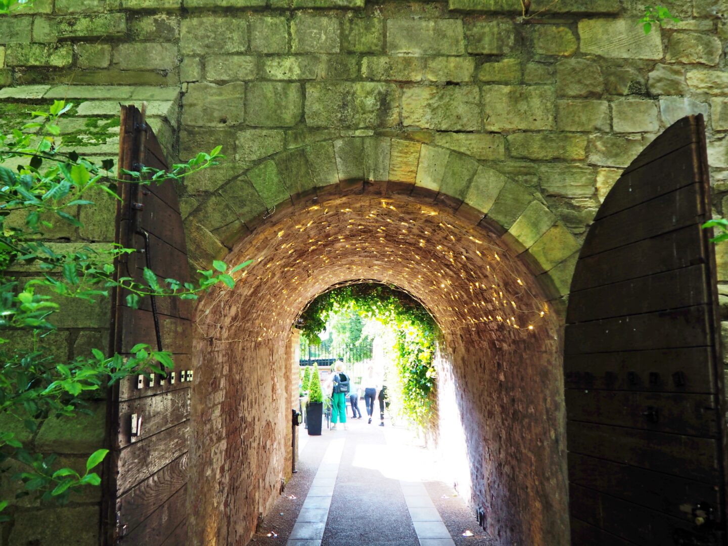 A passage with open doors, which is decorated with white twinkly lights