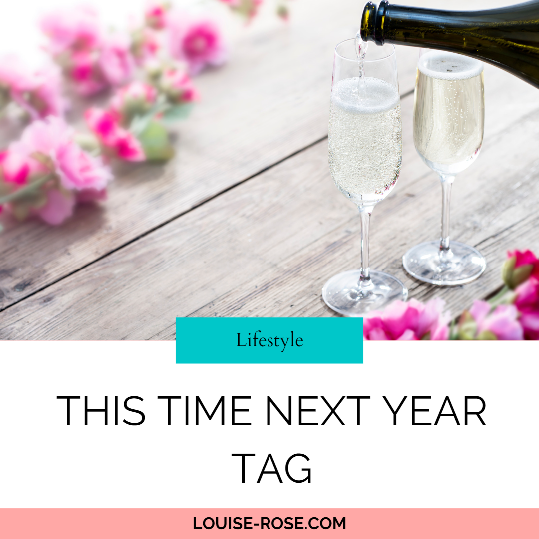 Prosecco being poured into a two glasses, with pink flowers on the table.