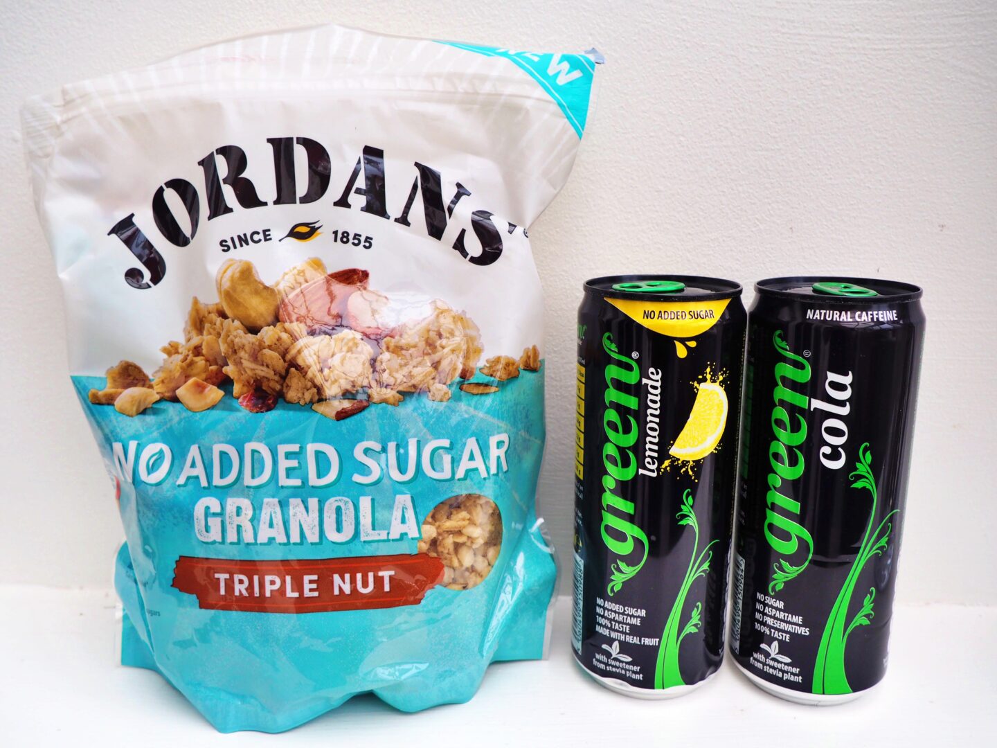 From left to right, a packet of Jordan's granola and a can of Green Lemonade and a can of Green Cola.