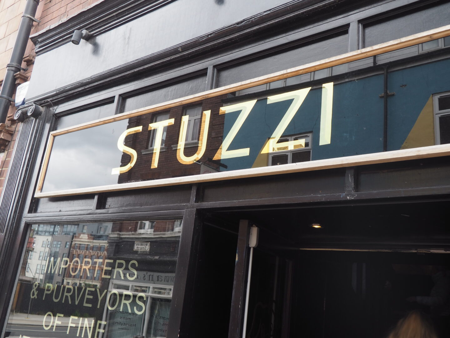 A photo of the signage above Stuzzi, a restaurant in Leeds.
