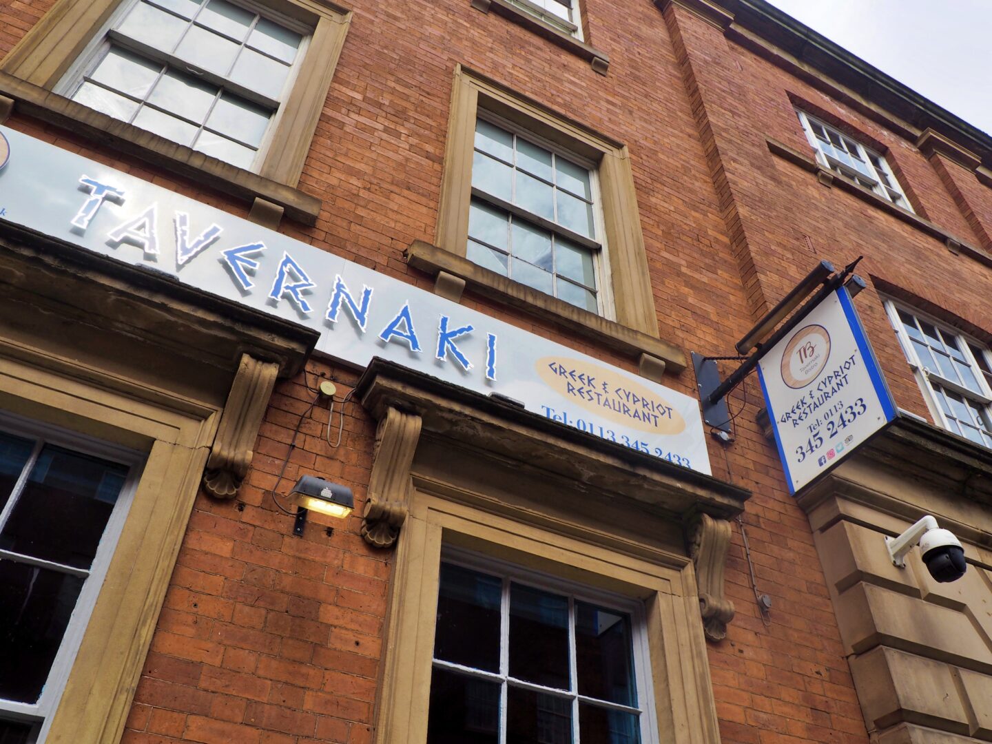 Photo shows the signage above the entrance to Tavernaki Bistro in Leeds.