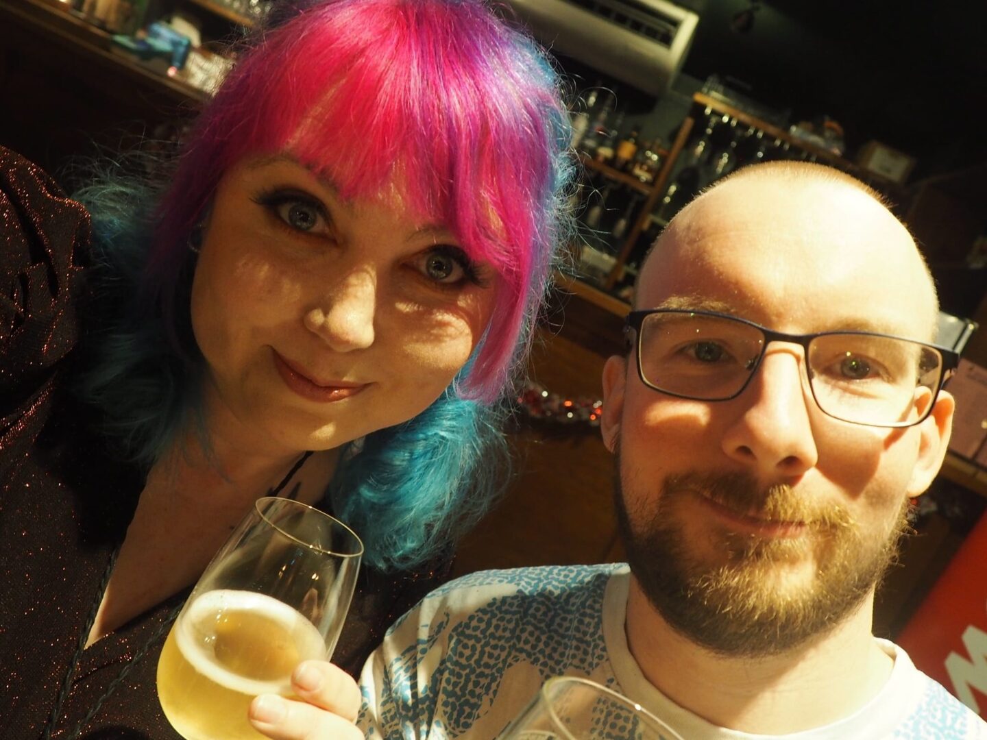 Myself, with pink and blue hair and my husband, Tom at Jet2's Festive Apres Ski Event in Leeds.